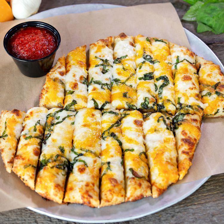 Knickerbocker Cheesy Bread · Our famous pizza dough made fresh daily, topped with hand-grated mozzarella, cheddar cheese, garlic and fresh basil, served with homemade marinara.