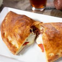 Meat Calzone · Sausage, pepperoni, bacon and hand-grated mozzarella, served with homemade marinara.