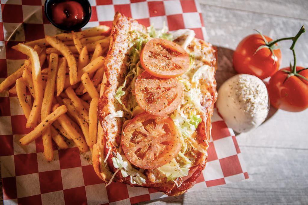 Italian Sandwich · Capicola, salami, ham, lettuce, tomatoes, melted hand-grated mozzarella, Italian dressing and oregano, served with pickled giardiniera on the side.