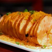 Tornado Potato · Spun, fried, and loaded with applewood smoked bacon, shredded cheddar, chives, and Sriracha ...