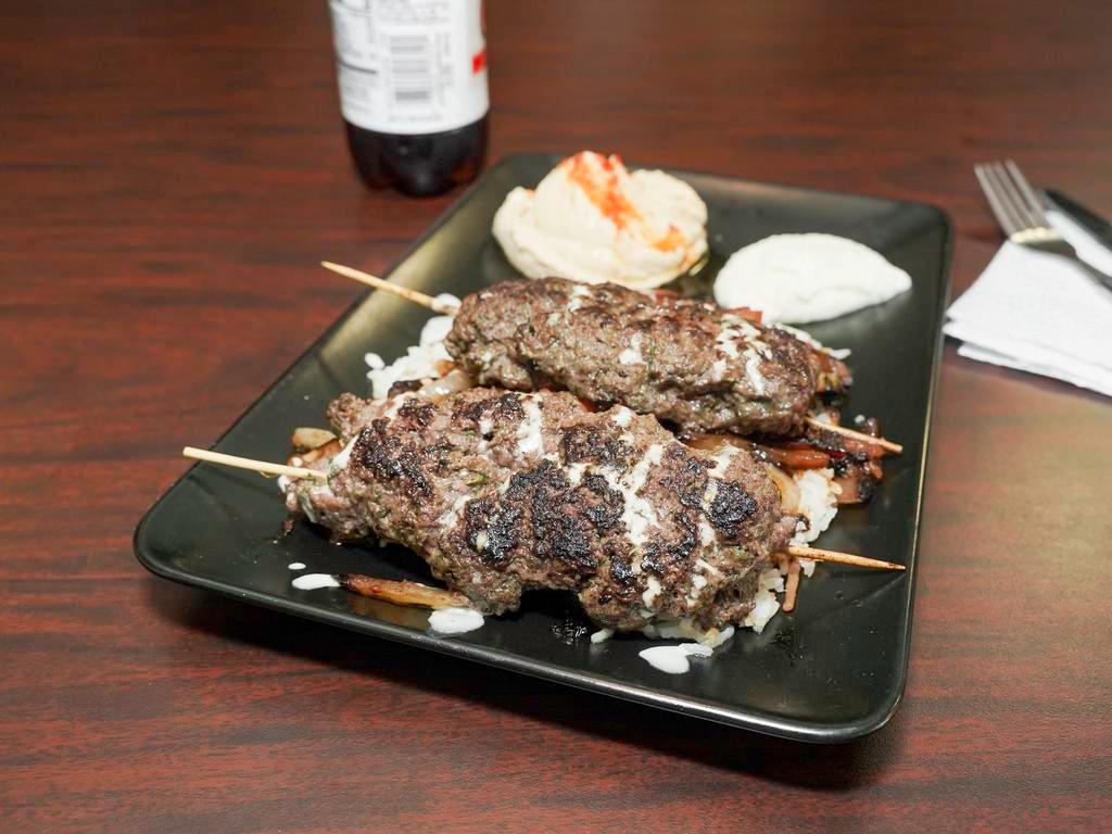 Beef Kabob Platter · Marinated grilled beef in garlic, olive oil, and lemon juice, served with sautéed vegetables on a bed of rice.