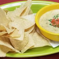 Queso Verde · Slow roasted green chile pork blended with queso blanco.  Served with chips.
