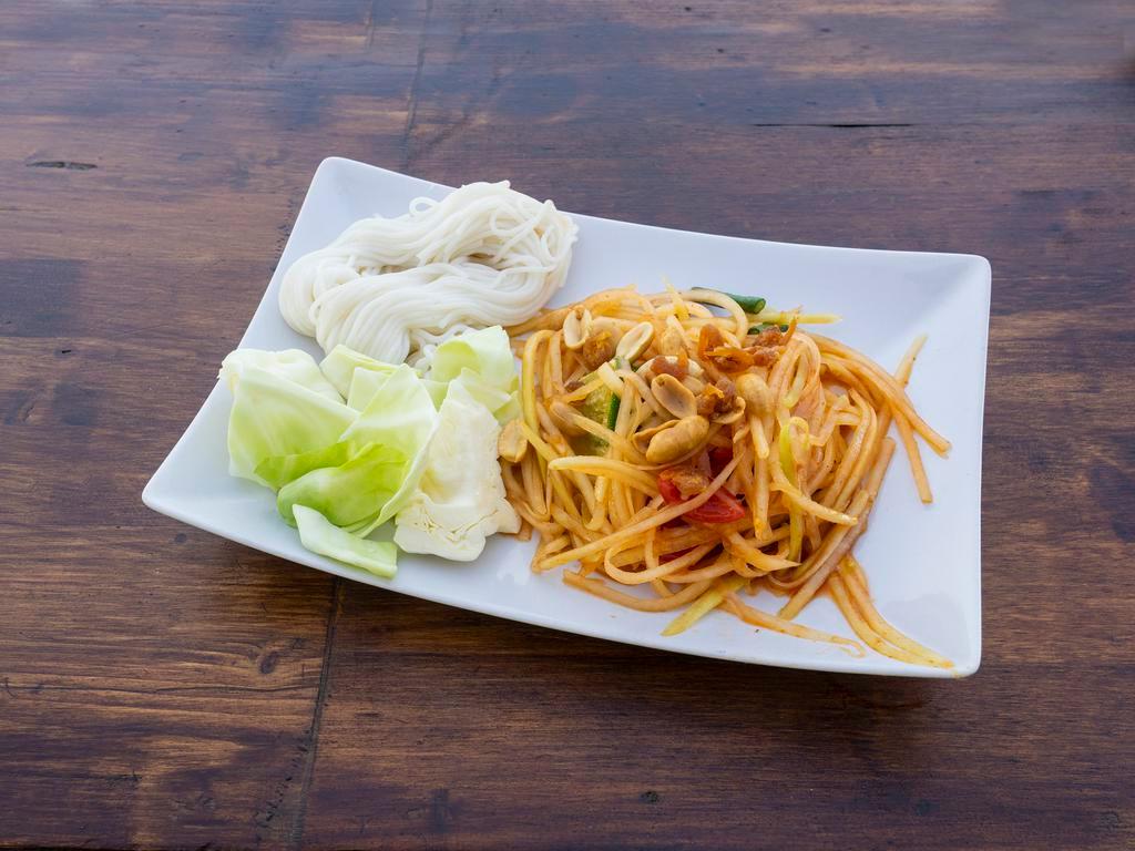 18. thai Papaya Salad · Som tum. Green papaya strips,  tomatoes, green bean, chili and peanut breaded in lime dressing. Spicy.