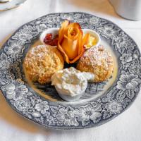 Classic British Scones · 2 house made scones. Served with butter, strawberry jam and fresh cream.