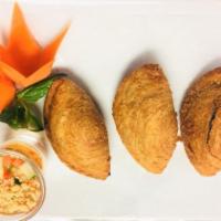 Curry Puffy · Glutinous rice flour stuffed with peas, carrots, potatoes, and curry powder deep-fried until...