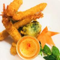 Shrimp Tempura · Deep-fried battered shrimps and broccoli. Served with a sweet and sour sauce.