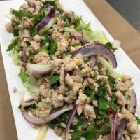 Larb Gai · Ground chicken, roasted rice, cilantro, green onions, red onions and citrus sauce. Spicy.