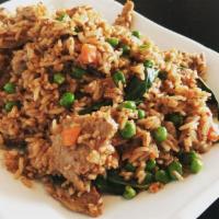 Thai Basil Fried Rice · Fried rice with peas, carrots, green onions, eggs, and basil.