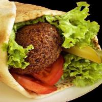 Falafel Wrap · Three Falafel pieces topped with Hummus, Lettuce, Tomatoes, Pickles and Tahini sauce and wra...
