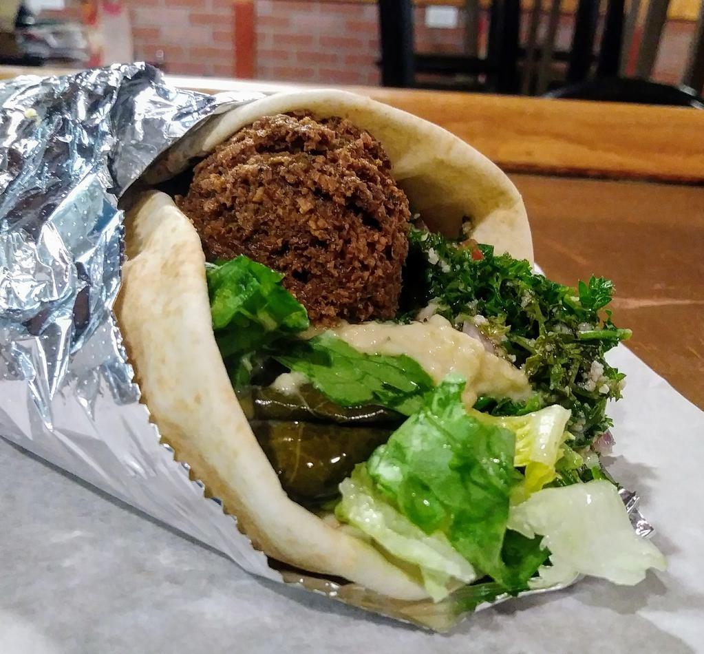 Veggie Combo Wrap · Falafel, Hummus, Baba Ganoush, Grape Leaves, Tabouleh and Tahini sauce, topped with Lettuce, Tomatoes and Pickles, and wrapped in a Fresh Pita.
