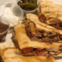 Chicken Quesadilla · Seasoned Chicken grilled with Onions, Peppers and Tomatoes topped with a Cheese Medley stuff...
