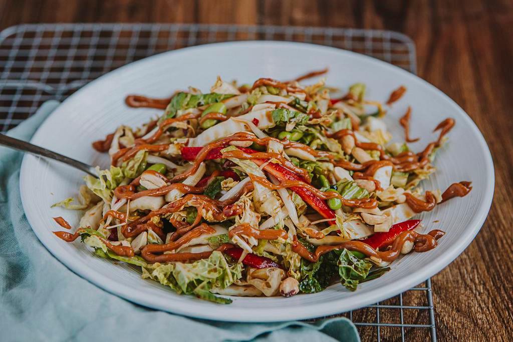 Soy Ginger · Napa cabbage, cucumber, red bell pepper, edamame, sprouts, peanuts, cilantro, soy-ginger dressing, spicy peanut sauce.