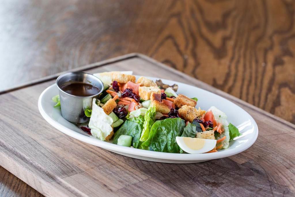 Greenhouse Salad · Mixed greens, tomatoes, carrots, cucumbers, dried cranberries, sunflower seeds, eggs, housemade croutons + choice of dressing. Vegetarian.