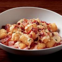 Spicy Cheese & Bacon Tots · Crispy tots, Paul's signature Wahl sauce, pickled red onion, bacon, spicy cheese sauce, nd P...