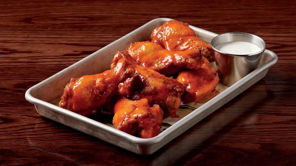 Wings · Choice of traditional or boneless. Choice of BBQ, Buffalo, or sweet chili glazed wings. Served with ranch or blue cheese dressing.  1060-1500 calories.