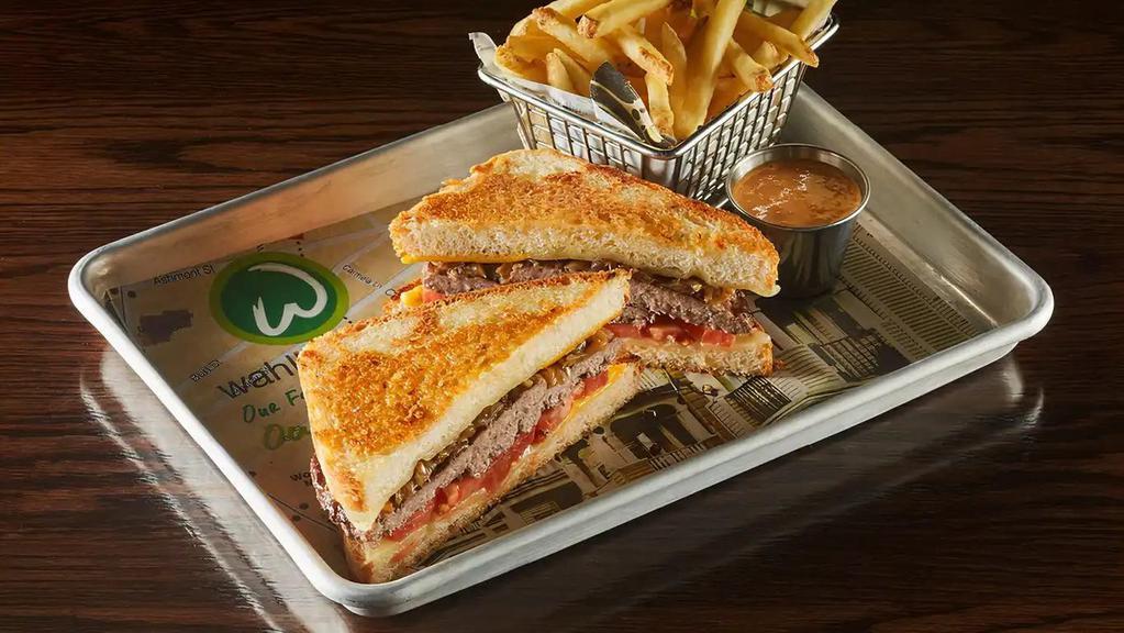 The Big Cheese · Two 1/4 lb. burger patties topped with government cheese, Swiss cheese, white cheddar cheese, caramelized onions, and tomatoes served between thick-cut bread, and grilled with Asiago cheese.  1200 calories.