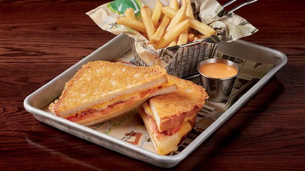 Grown-Up Grilled Cheese · Swiss cheese, white cheddar cheese, government cheese, tomato, and bacon jam served between thick-cut bread and grilled with Asiago cheese.  730 calories.
