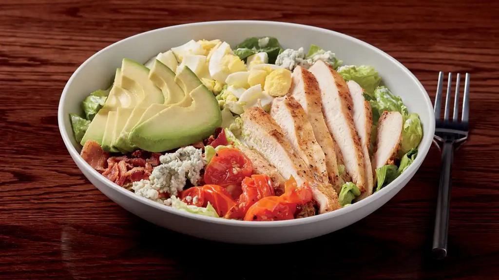 Cobb Salad · marinated seared chicken, mixed greens, toasted cherry tomatoes, hard-boiled egg, crumbled blue cheese, avocado slices, and bacon bits served with housemade blue cheese dressing.  520 calories.