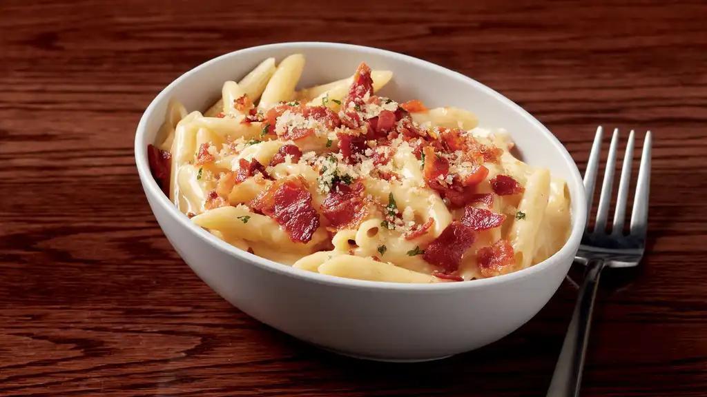 Smoked Bacon Mac N Cheese · Penne, bacon, government cheese and cheddar topped with housemade garlic Parmesan Panko breadcrumbs.  840 calories.