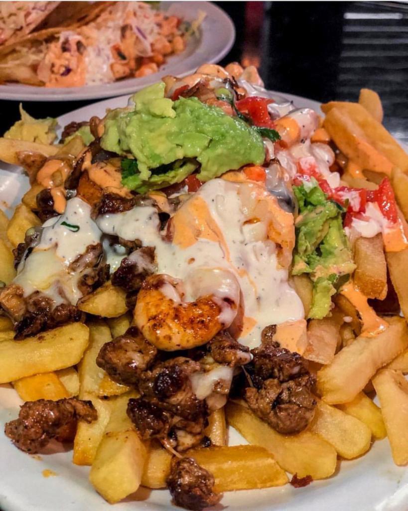 Surf and Turf Fries · French fries topped with mozzarella cheese, sautéed onions, mild Anaheim pepper, carne asada, & grilled shrimp. Garnished with aioli, chipotle aioli, pico de gallo & guacamole (Guac if in season)