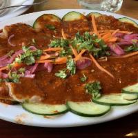 Aguachile Rojo · Uncooked butterflied shrimp marinated in lime juice & a chile de arbol sauce, over a bed of ...