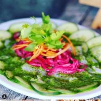 Aguachile Verde · Uncooked butterflied shrimp marinated in lime juice & a serrano chile sauce, over a bed of c...
