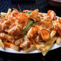 Buffalo Shrimp Fries · Battered shrimp tossed in buffalo sauce, topped with mozzarella cheese, chipotle sauce, ranc...