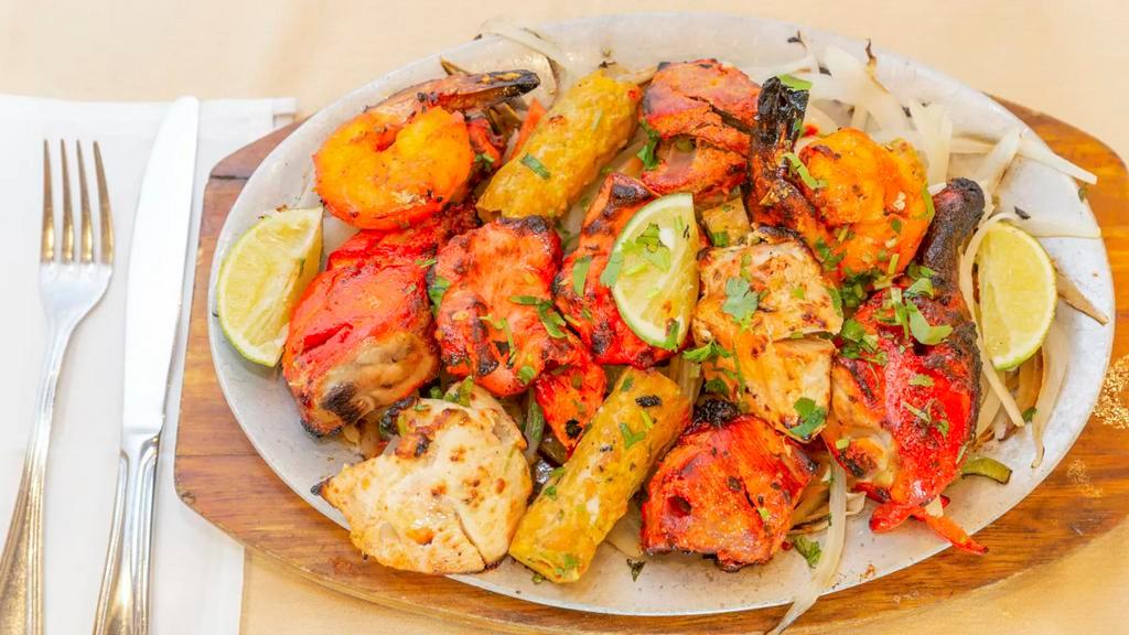 Tandoori Mixed Grill · A combination of our appetizing tandoori chicken, seekh kabab, shrimp tandoori, boti kabab, chicken tikka and malai kabab.