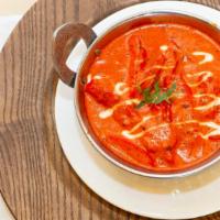 Chicken Makhani · Tandoor baked chicken cooked in a oriental spices with tomatoes and butter.