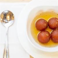 Gulab Jamun · Milk and cheese balls dipped in syrup, served warm.