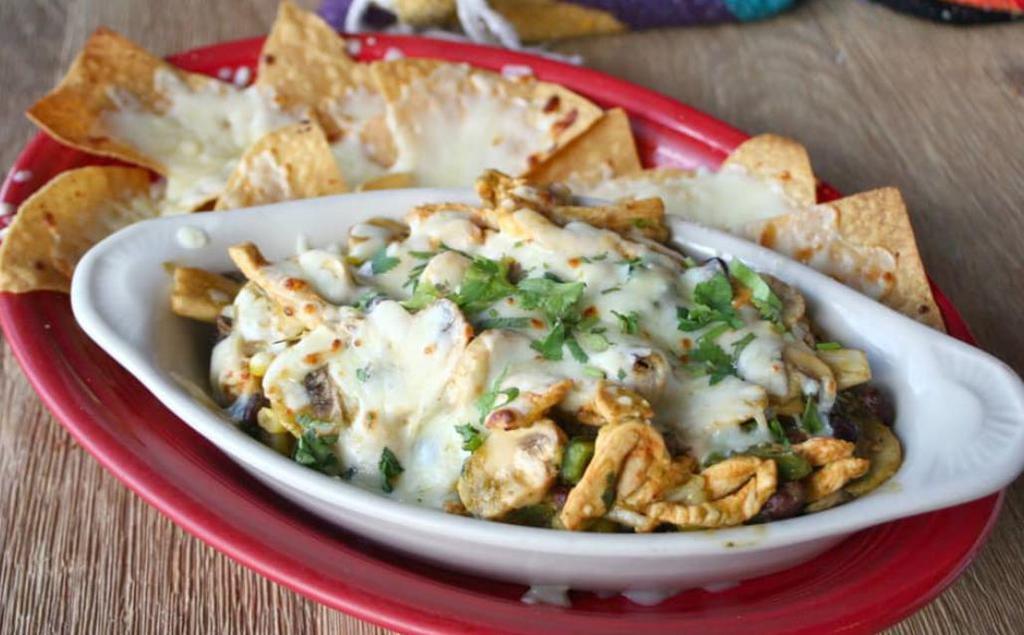 Spicy Pollo Verde Bake Specialty · Marinated chunks of chicken breast sautéed with lime, fresh jalapeño, mushrooms,
black bean and corn salsa and verde sauce, covered with cheese and baked over
cilantro-lime rice. Served with cheese covered tortilla chips.