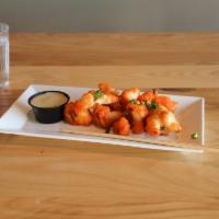 Fried Cauliflower Bites · Tempura battered cauliflower, fried and served with your choice of sauce on the side. Garnis...