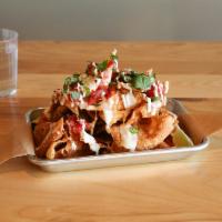 Wonton Nachos · House cut and fried wonton chips and topped with queso blanco, pico de gallo, shredded chick...