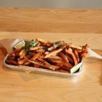Kamikaze Fries · Hand cut, Cajun seasoned fries and topped with fresh cut cilantro and lime wedges. Served wi...