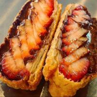 Strawberry Nutella Eggrolls · Fresh strawberries and rich Nutella, rolled into an Eggroll and deep fried, served open face...
