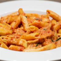 Karen's Pasta · Chicken and artichokes tossed with penne pasta in a creamy tomato basil sauce.
