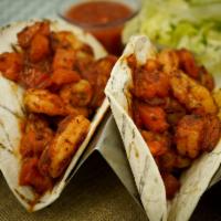 Shrimp Tacos · Chipotle tomato sauce, cabbage lime slaw, cilantro, black beans