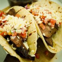 Steak tacos · Flank steak, pico, queso fresco, black beans