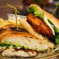 Crispy Chicken Sandwich · topped with a black bean puree, crushed avacoda, Oaxaca string cheese and cilantro served on...