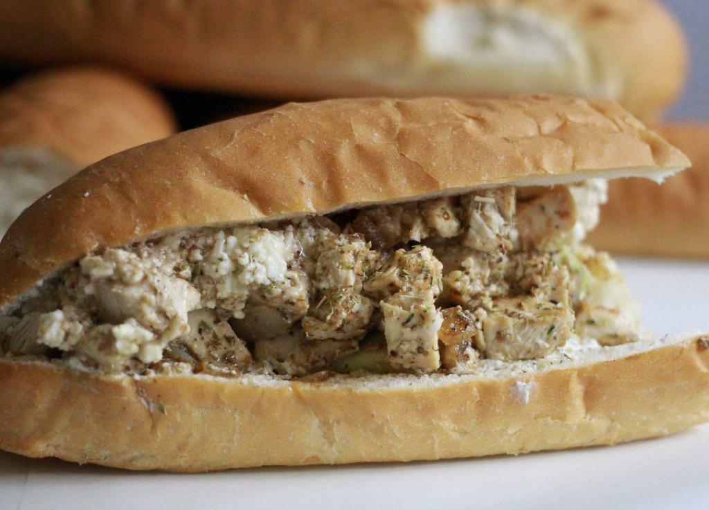 Greek Chicken Sub · We Grill our Fresh, Hormone Free, Hand Trimmed All White meat Chicken Breast Everyday ! It Comes With Homemade Tzatziki sauce, Cucumber, Feta Cheese, Greek Oregano & our House made Awesome Sauce on the Side!!