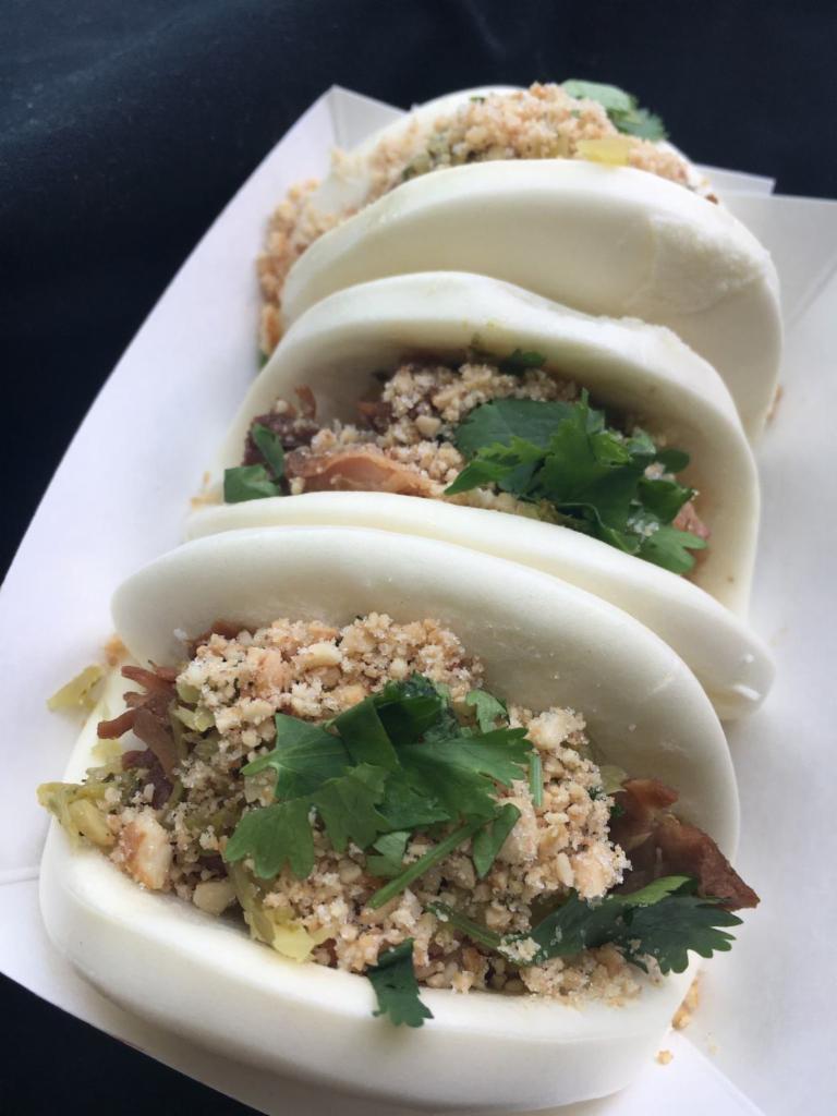 2 Piece Gua Bao · pork belly braised overnight in Chinese spice, wrapped in soft steamed bun, garnished with Taiwanese style pickles, cilantro and crushed peanuts.
