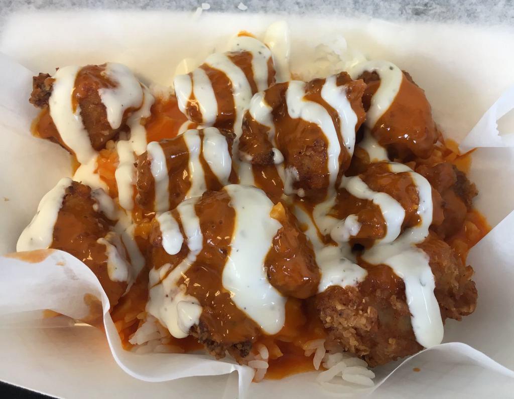 The Buffalo · Frank's original. Crispy chicken (breaded chicken breast) or grilled chicken with Buffalo sauce with choice of ranch or blue cheese drizzle, served over jasmine rice.