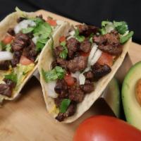 2 Piece Steak Tacos · Soft flour tortilla with diced carne asada, shredded lettuce, chopped tomato and drizzled wi...
