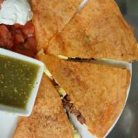 Breakfast Quesadilla · Tomato basil tortilla filled with organic scrambled eggs, pepper jack cheese, red and green ...