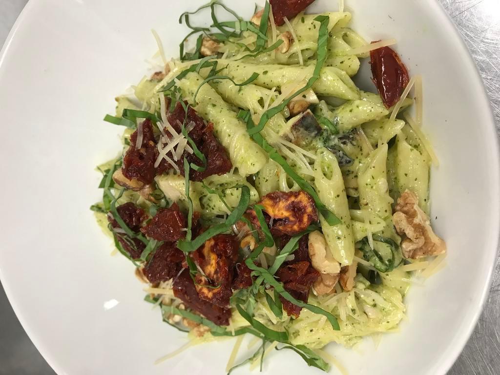 Creamy Pesto Penne with Chicken · Penne pasta, grilled chicen cream, parmesan cheese, sun dried tomatoes, garlic