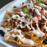 Nachos Supreme · Homemade fried tortilla chips, baked and topped with queso, ground beef, shredded chicken, b...
