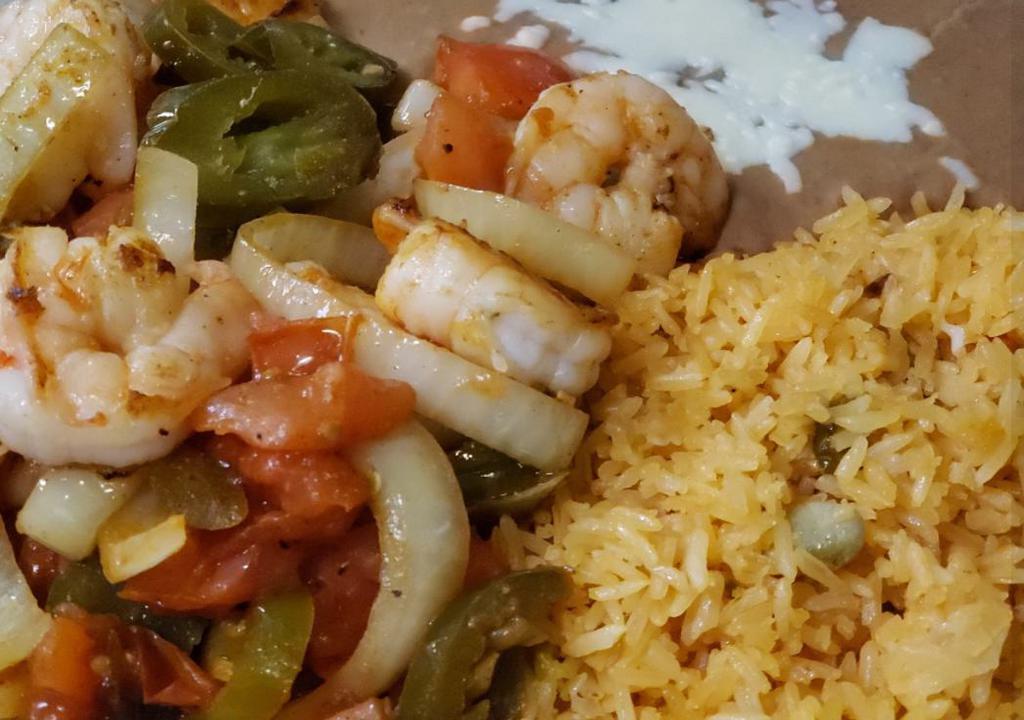 Camarones Tapatios · Jumbo shrimp grilled with jalapenos, onions and tomatoes. Served with rice, beans and flour tortillas.
