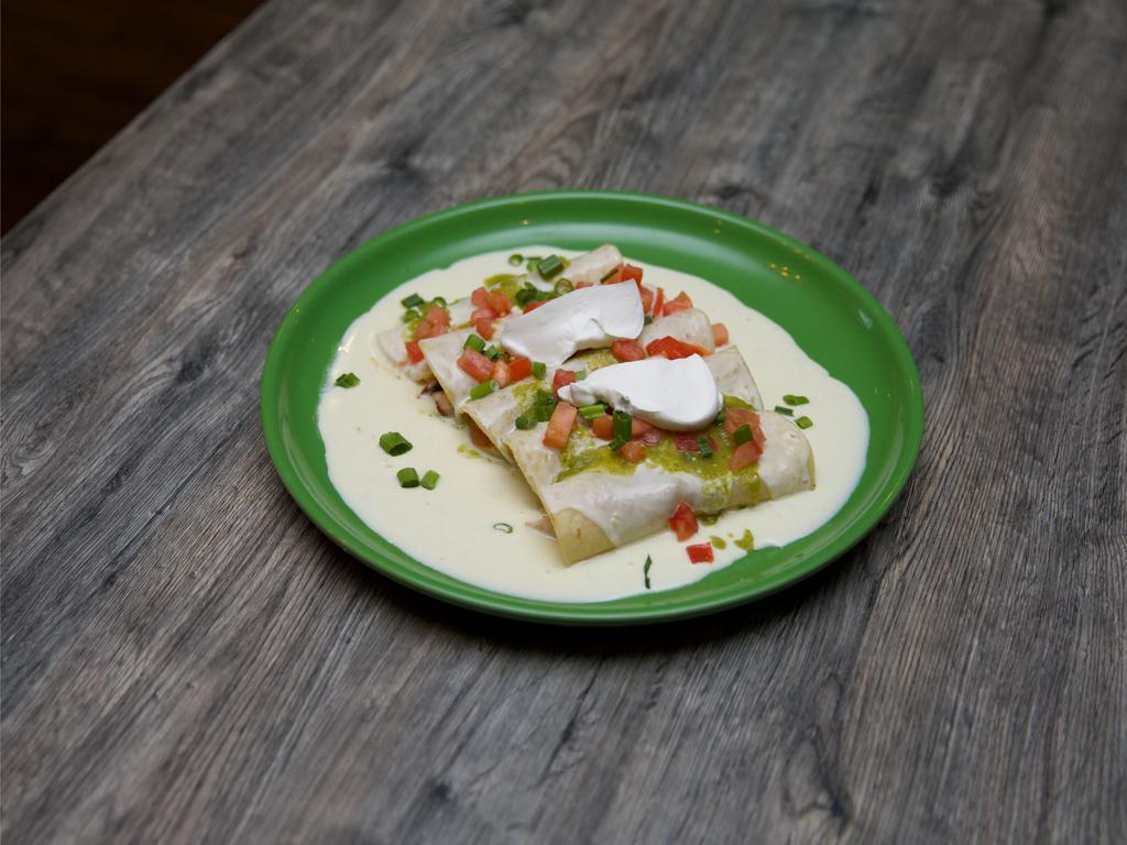 Cantina Del Rio Enchiladas · 5 fresh corn tortillas filled with marinated grilled chicken and topped cheese sauce, green tomatillo sauce, sour cream, green onions, and diced tomatoes.