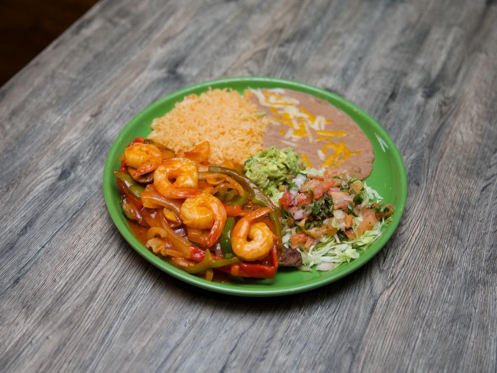 Lomo Asado · New York steak with garlic shrimp, tomatoes, onions, and mushrooms in our special sauce.