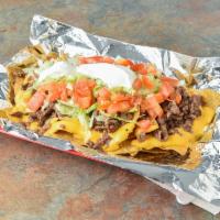 Nachos · Steak, ground beef, al pastor or chicken with chips, lettuce, tomatoes, nacho cheese and sou...